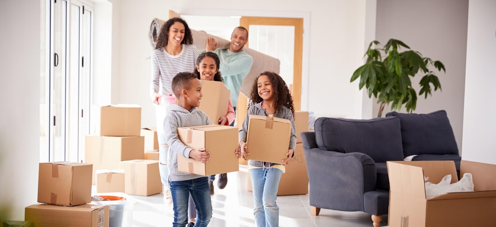 a family carrying boxes out of a home