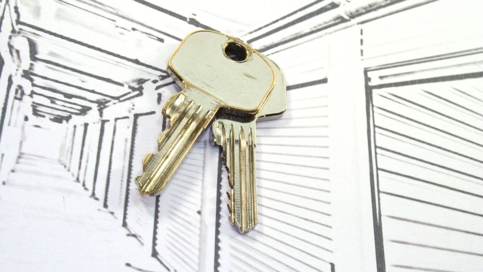 A pair of keys resting on a storage door.